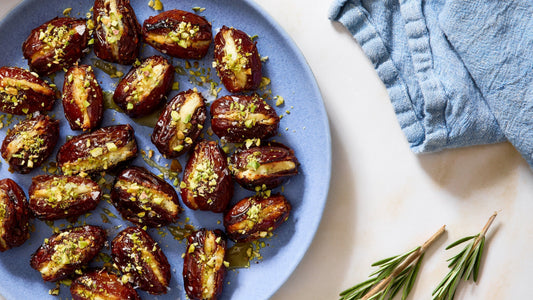 A blue dinner plate filled with Goat Cheese Stuffed Dates.