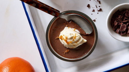Chocolate Orange Budino with a dollop of creme fraiche and a spoon.